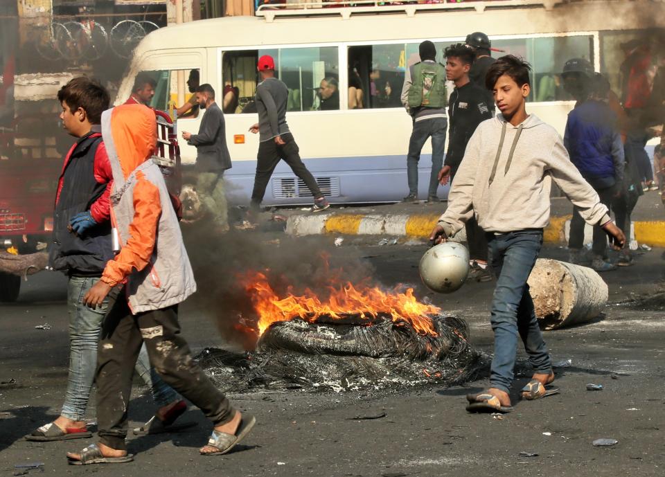 Protesters set fires during ongoing protests in Baghdad, Iraq, Sunday, Dec. 1, 2019. Iraq's parliament approved the resignation of Prime Minister Adel Abdul-Mahdi on Sunday, amid ongoing violence and anti-government demonstrations in the capital. (AP Photo/Hadi Mizban)