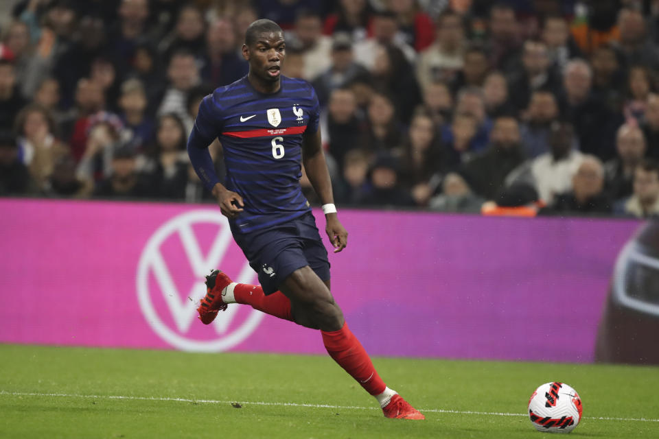 FILE - France's Paul Pogba runs with the ball during an international friendly soccer match between France and Cote d'Ivoire at the Velodrome stadium in Marseille, southern France, on March 25, 2022. Pogba will miss the World Cup with ongoing knee problems. (AP Photo/Daniel Cole, File)