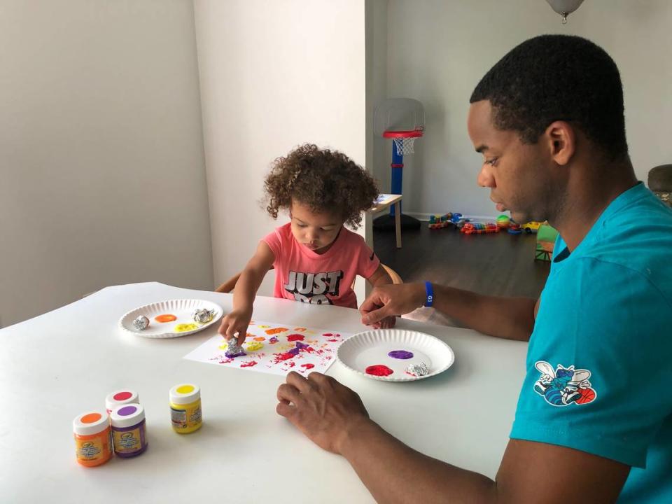 Charlotte Hornets assistant coach Ron Nored, right, paints with his 2-year-old daughter Avery at home on April 14, 2020. Nored is using the extra time he’s being able to spend at home due to the coronavirus pandemic to have more family time.