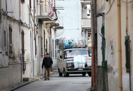 A man walks in Pomigliano D'Arco, near Naples, Italy, February 21, 2018. Picture taken February 21, 2018. REUTERS/Alessandro Bianchi