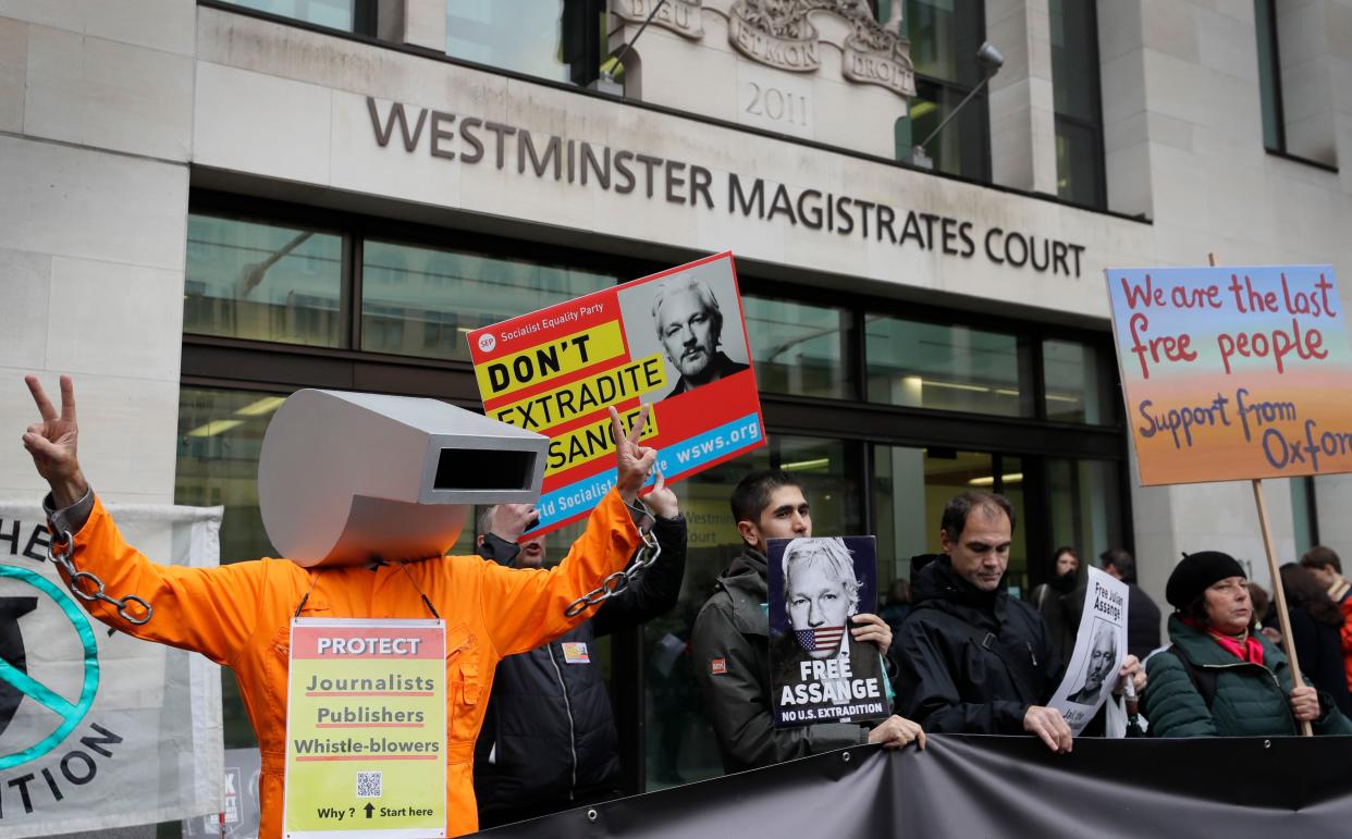 Supporters of Wikileaks founder Julian Assange demonstrate outside Westminster Magistrates' Court in London where Assange is expected to appear as he fights extradition to the United States on charges of conspiring to hack into a Pentagon computer, in London, Monday, Oct. 21, 2019.