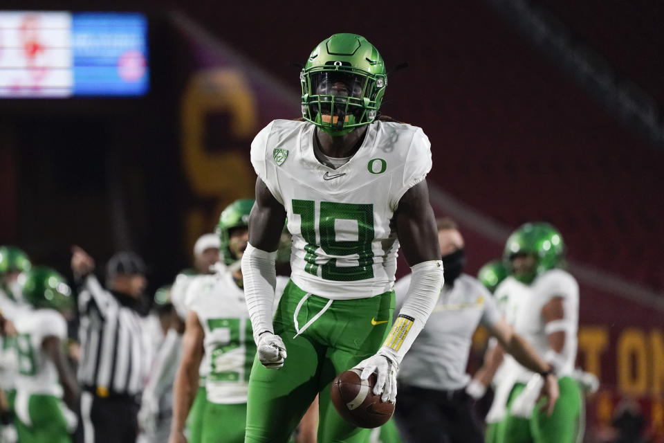 Oregon safety Jamal Hill (19) celebrates after a play during the first quarter of an NCAA college football game for the Pac-12 Conference championship against Southern California Friday, Dec 18, 2020, in Los Angeles. (AP Photo/Ashley Landis)