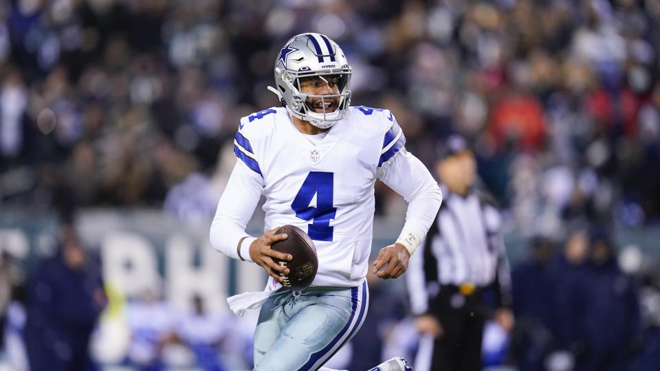 Dallas Cowboys quarterback Dak Prescott rolls out during the first half of an NFL football game between the Philadelphia Eagles and the Dallas Cowboys, Saturday, Jan. 8, 2022, in Philadelphia. The Cowboys won 51-26. (AP Photo/Julio Cortez)