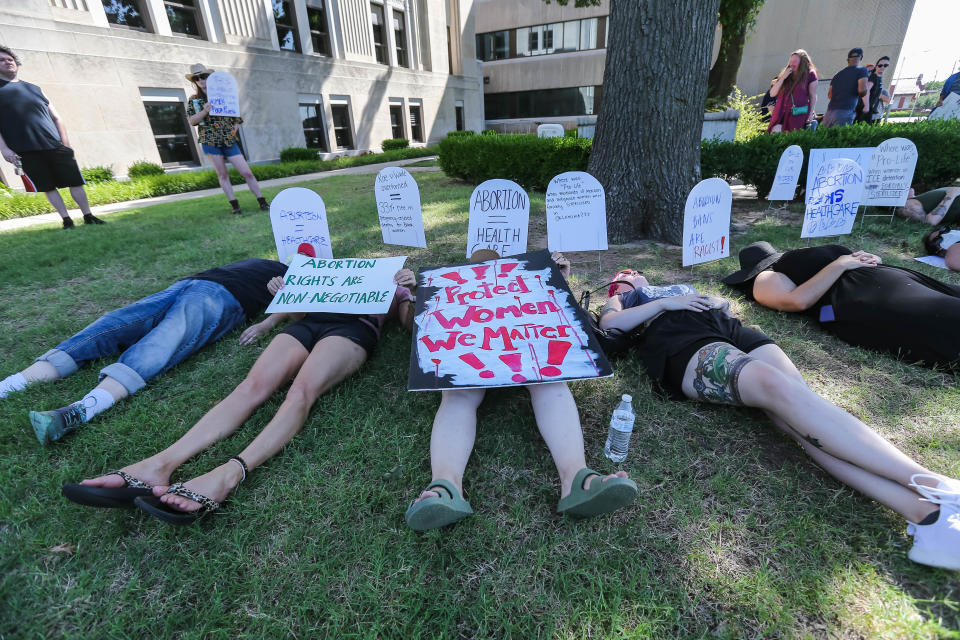 Demonstrators lay on the ground at the Cleveland County Courthouse in Norman on Friday, June 24, 2022, to protest the complete ban on abortions in Oklahoma after the U.S. Supreme Court’s decision to reverse Roe v. Wade.