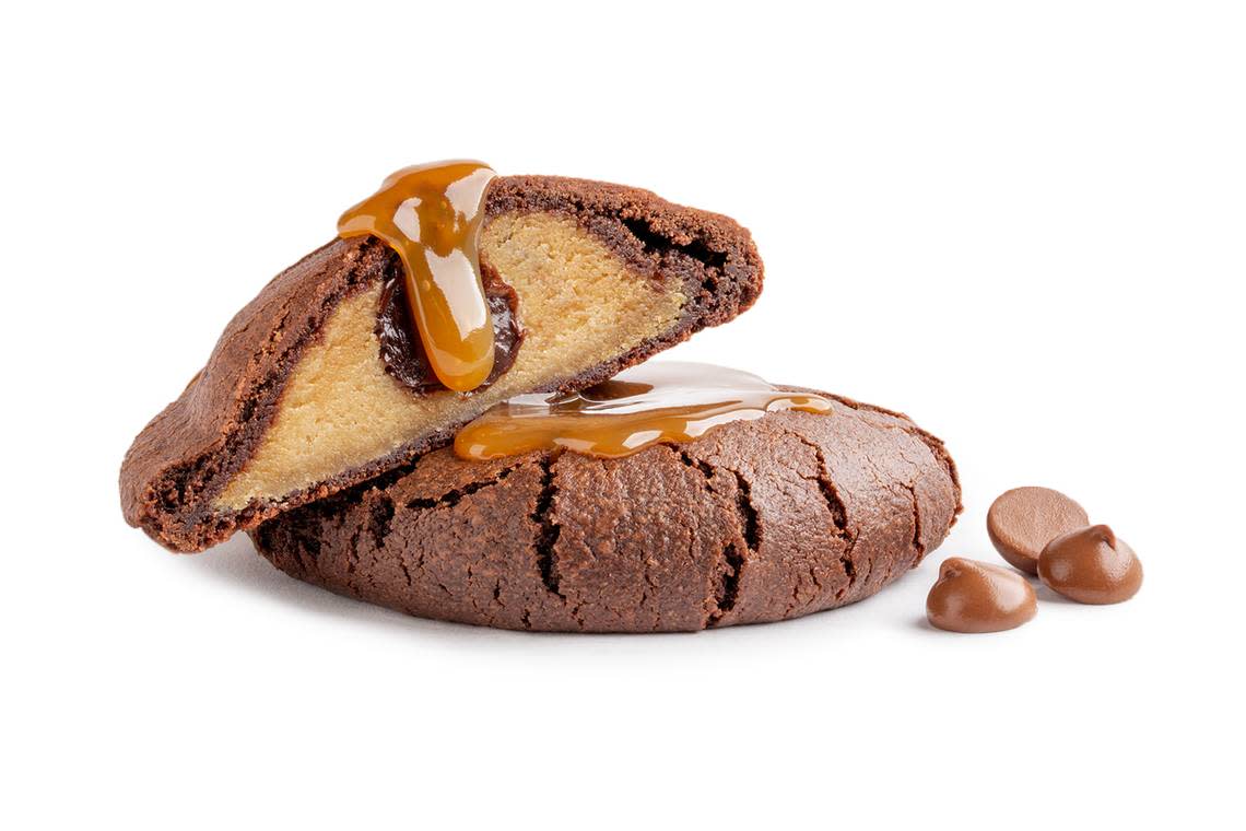 The Brookie cookie at Dirty Dough is a combination of brownie and chocolate chip cookie filled and drizzled in caramel sauce.