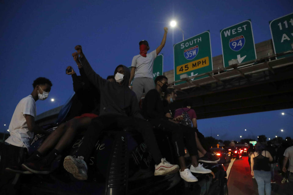 Protesters move along a highway Friday, May 29, 2020, in Minneapolis. Protests continued following the death of George Floyd who died after being restrained by Minneapolis police officers on Memorial Day. (AP Photo/Julio Cortez)