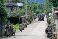 <p>Government troops head to the frontline as fighting with Muslim militants in Marawi city enters its second week Tuesday, May 30, 2017, in the southern Philippines. Philippine forces pressed their offensive to drive out militants linked to the Islamic State group after days of fighting left corpses in the streets and hundreds of civilians begging for rescue from a besieged southern city of Marawi. (Bullit Marquez/AP) </p>