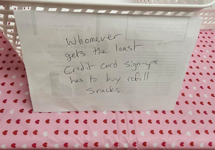 Handwritten note stating, "Whomever gets the least Credit Card sign-ups has to buy retail snacks."