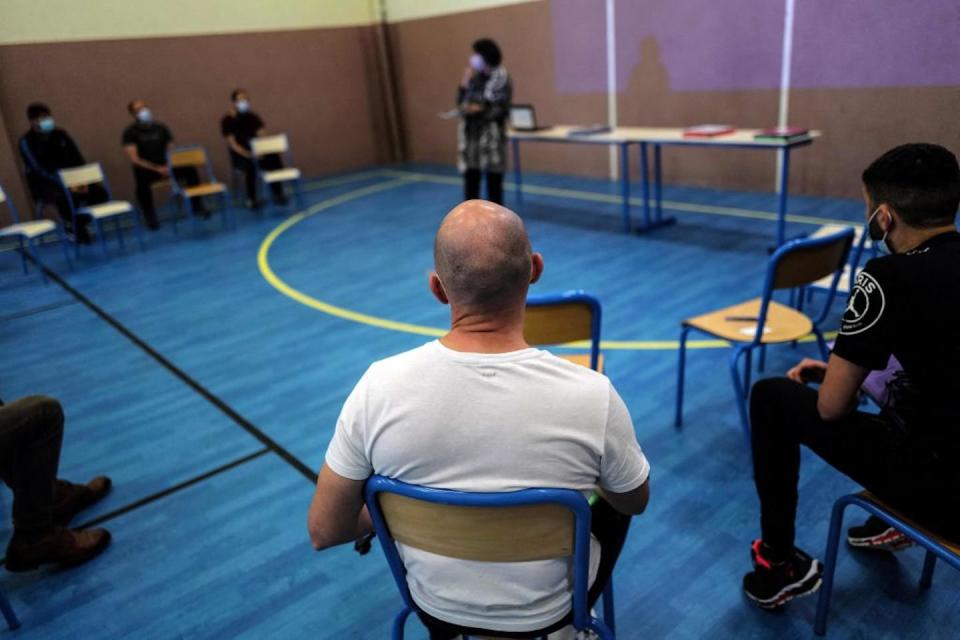 Prisoners in France wait to receive computers they will be allowed to keep in their cells to do schoolwork. <a href="https://www.gettyimages.com/detail/news-photo/prisoners-wait-to-get-a-computer-in-the-prison-of-news-photo/1232073840?phrase=degree%20prison&adppopup=true" rel="nofollow noopener" target="_blank" data-ylk="slk:Olivier Chassignole/AFP via Getty Images;elm:context_link;itc:0;sec:content-canvas" class="link ">Olivier Chassignole/AFP via Getty Images</a>
