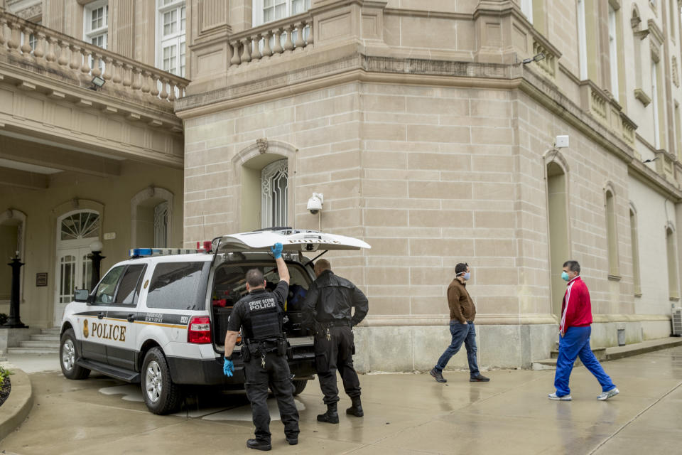 Secret Service officers investigate after police say a person with an assault rifle opened fire at the Cuban Embassy, Thursday, April 30, 2020, in Washington. Officers found the suspect with an assault rifle and took the person into custody without incident, police said. (AP Photo/Andrew Harnik)