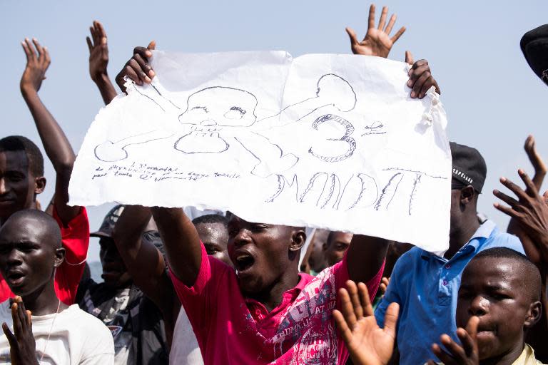 Protestors opposed to the bid by Burundian President Pierre Nkurunziza to stand for a third term hold a banner reading "Avenue of Democracy" at a demonstration on May 29, 2015 in Bujumbura