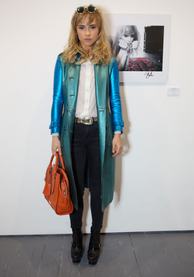 Celebrities in metallic fashion: Suki Waterhouse wore a two-tone Burberry trench to her photography exhibition.<br><br>[Hoxton Gin]