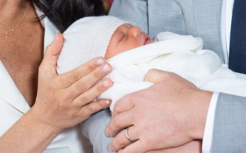 The Duke and Duchess of Sussex with their baby son, who was born on Monday morning, during a photocall in St George's Hall at Windsor Castle - Credit: Dominic Lipinski/PA Wire