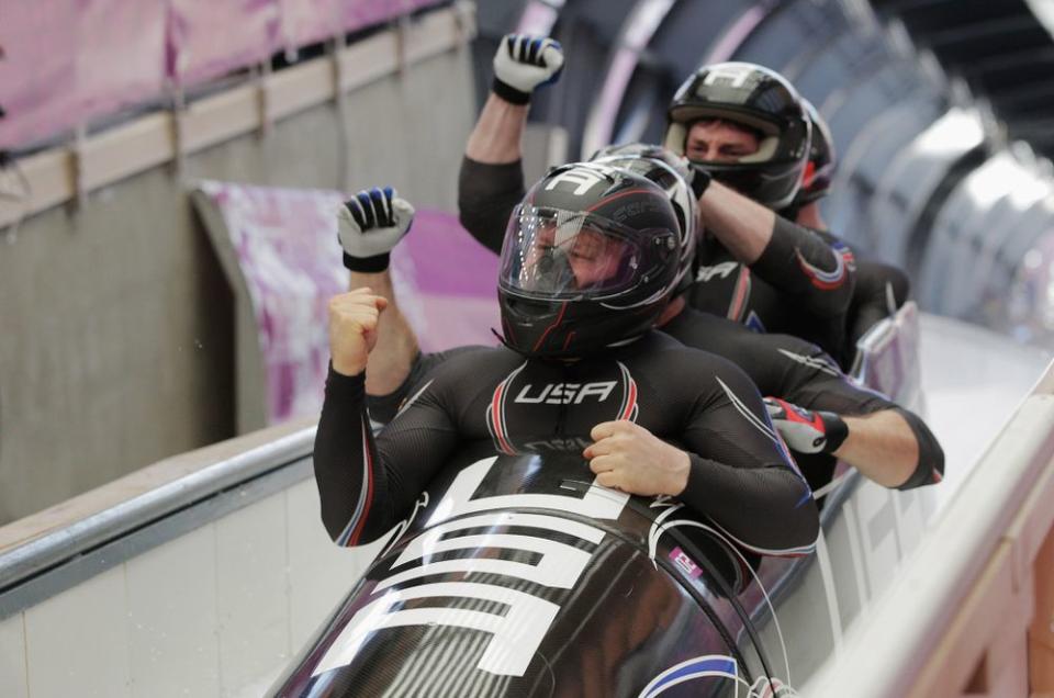 Steven Holcomb with teammates during the Sochi 2014 Winter Olympics | Adam Pretty/Getty Images