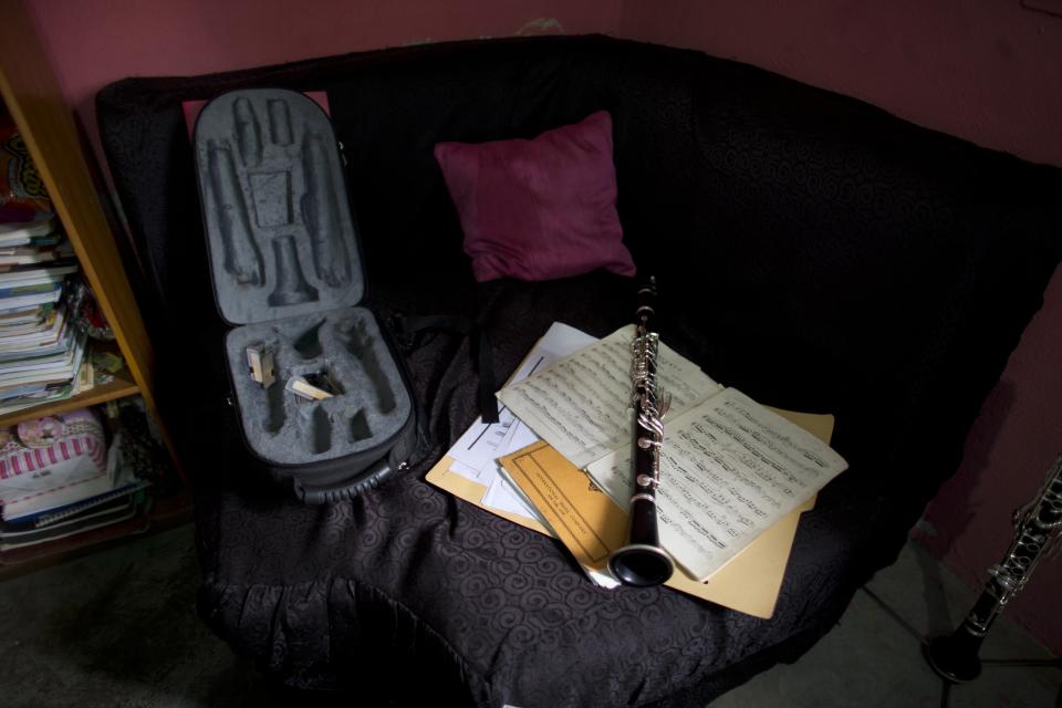 Karen Palacios' Yamaha clarinet still rests atop the sheet music of Mozart's concerto for the instrument that she diligently practiced the night two strangers dressed in black took her away in a luxury SUV, at her house in Los Teques in the outskirts of Caracas, Venezuela, Tuesday, July 16, 2019. Palacios who was cut from the National Philharmonic for criticizing the government, and who was detained for 6 weeks, was released today. (AP Photo/Ariana Cubillos)