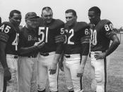 FILE - Chicago Bears coach George Halas discusses the upcoming season with four of his second-year men at training camp in July 1966 at St. Joseph's College in Rensselaer, Ind. With Halas at picture session are Dick Gordon (45), Dick Butkus (51), Mike Reilly (62) and Jimmy Jones (80). Butkus, a fearsome middle linebacker for the Bears, has died, the team announced Thursday, Oct. 5, 2023. He was 80. According to a statement released by the team, Butkus' family confirmed that he died in his sleep overnight at his home in Malibu, Calif. (AP Photo, File)