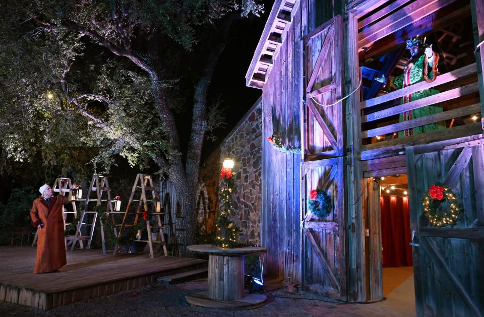 From left, Jonathan Beck Reed plays Ebenezer Scrooge and Caleb Barnett as the Ghost of Christmas Present in Lyric Theatre's 2022 production of "A Christmas Carol" at the Harn Homestead.