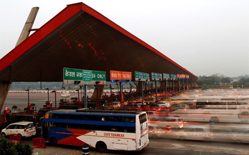 FILE PHOTO: Vehicles pass through a toll plaza in Gurgaon on the outskirts of New Delhi, India