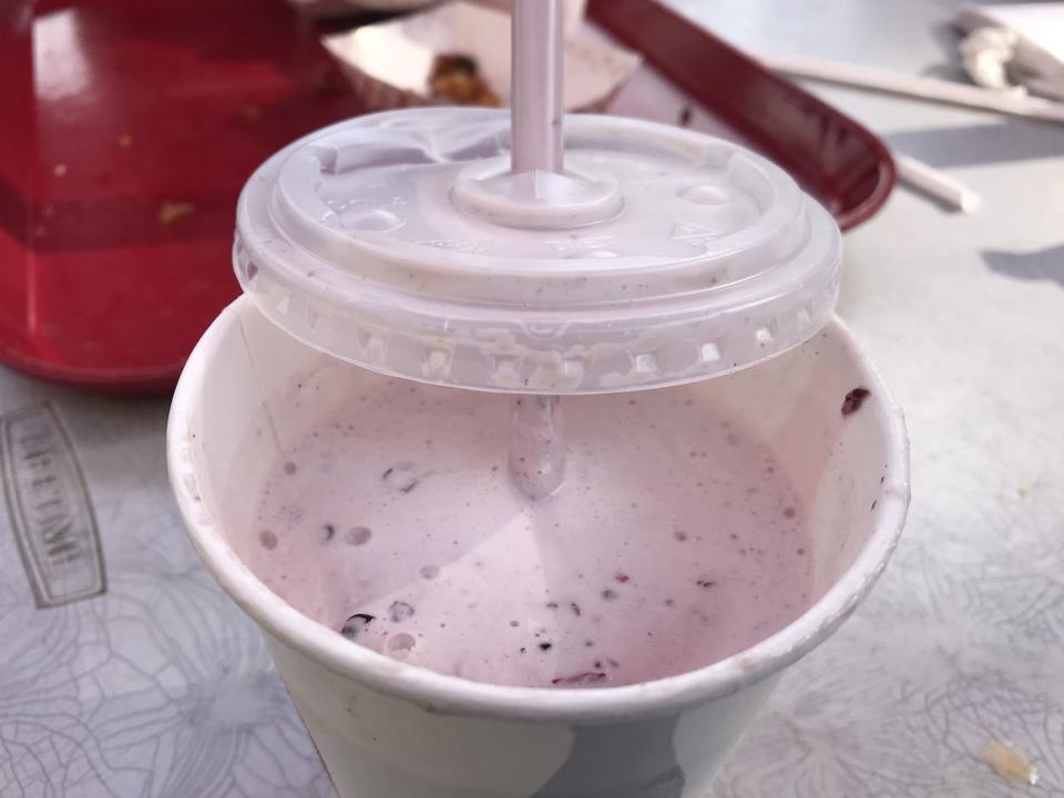 Blackberry milkshake in white cup from arctic roadrunner in alaska