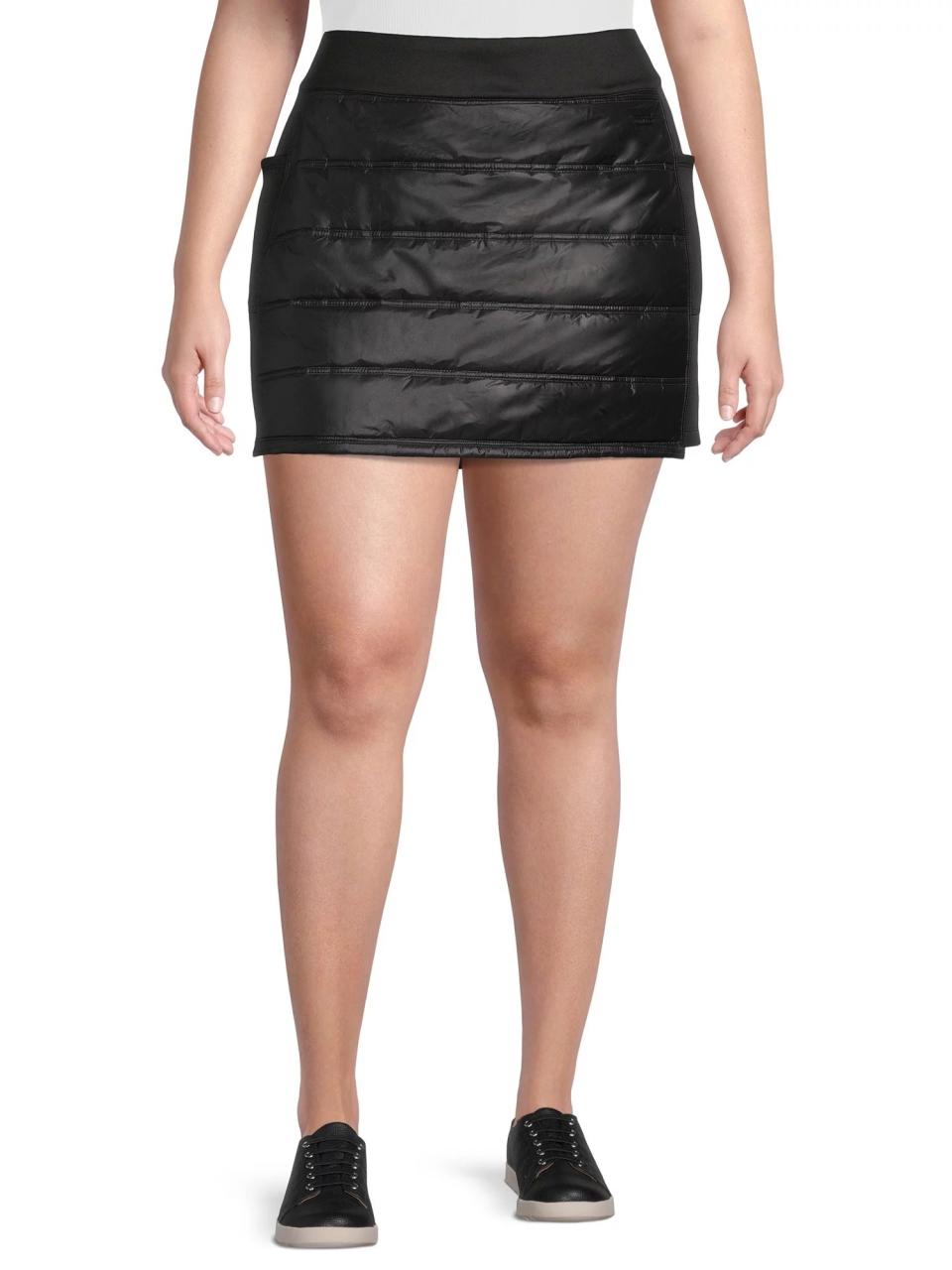 Model wearing black skirt with black shoes and white top