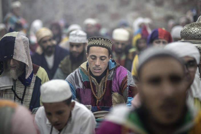 Members of the Sufi Karkariya order chant hymns during a religious celebration to mark the prophet Muhammed's birthday, in Aroui, near Nador, eastern Morocco, Monday, Oct. 18, 2021. (AP Photo/Mosa'ab Elshamy)