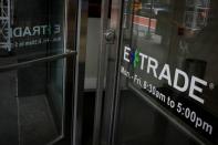 A man enters E*Trade Financial offices, after it was announced that Morgan Stanley is buying the discount brokerage, in New York