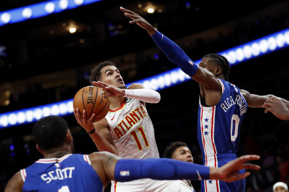 Atlanta Hawks guard Trae Young (11) goes up to shoot as Philadelphia 76ers guard Josh Richardson (0) defends in the first half of an NBA basketball game Monday, Oct. 28, 2019, in Atlanta. (AP Photo/John Bazemore)