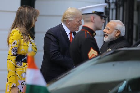 U.S. President Donald Trump (C) and first lady Melania Trump welcome Indian Prime Minister Narendra Modi (R) to the White House in Washington, U.S., June 26, 2017. REUTERS/Carlos Barria