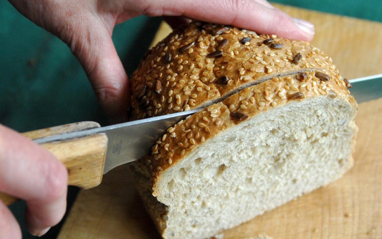 The cutting of a loaf of bread, which will soon contain folic acid - PA