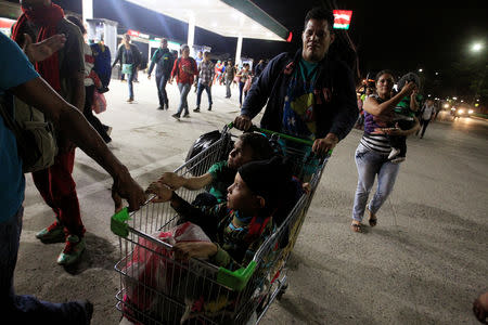 Hondurans take part in a new caravan of migrants, set to head to the United States, as they leave San Pedro Sula, Honduras January 14, 2019. REUTERS/Jorge Cabrera