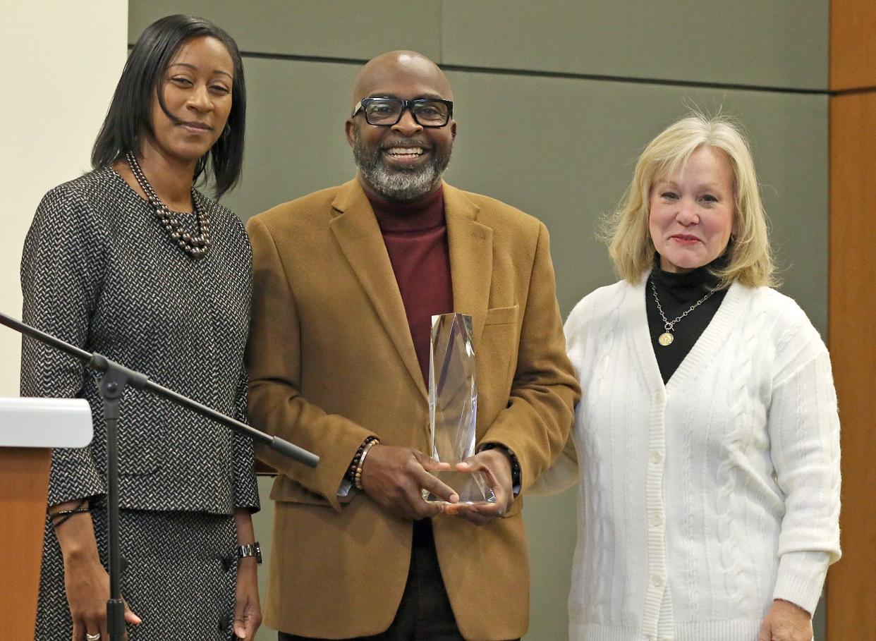 Gastonia City Councilwoman Donyel Barber, left, and Duke Energy director Martha Wegner present the Duke Energy Leadership & Citizenship Award to Pastor Rodney Freeman during the Gaston Business Association Annual Meeting & Celebration held Friday, Dec. 2, 2022, at the Gastonia Conference Center.