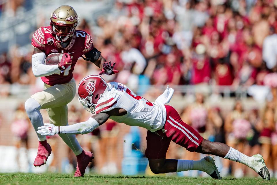 Florida State Seminoles wide receiver Darion Williamson (21) tries to outrun a tackle. The Florida State Seminoles defeated the Massachusetts Minutemen 59-3 at Doak Campbell Stadium on Saturday, Oct. 23, 2021.