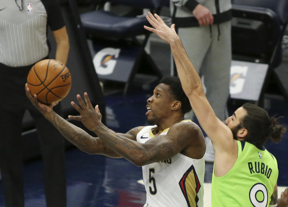 New Orleans Pelicans Eric Bledsoe (5) shoots against Minnesota Timberwolves guard Ricky Rubio (9) in the first quarter during an NBA basketball game, Saturday, Jan. 23, 2021, in Minneapolis. (AP Photo/Andy Clayton-King)