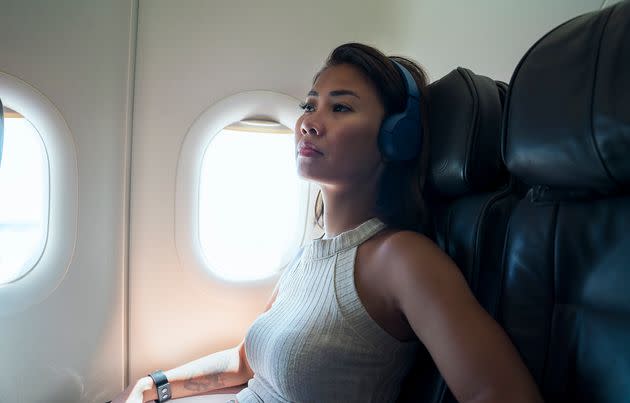 Noise-canceling headphones, comfortable clothing and a nice neck pillow can make all the difference on a long flight. (Photo: Enes Evren via Getty Images)