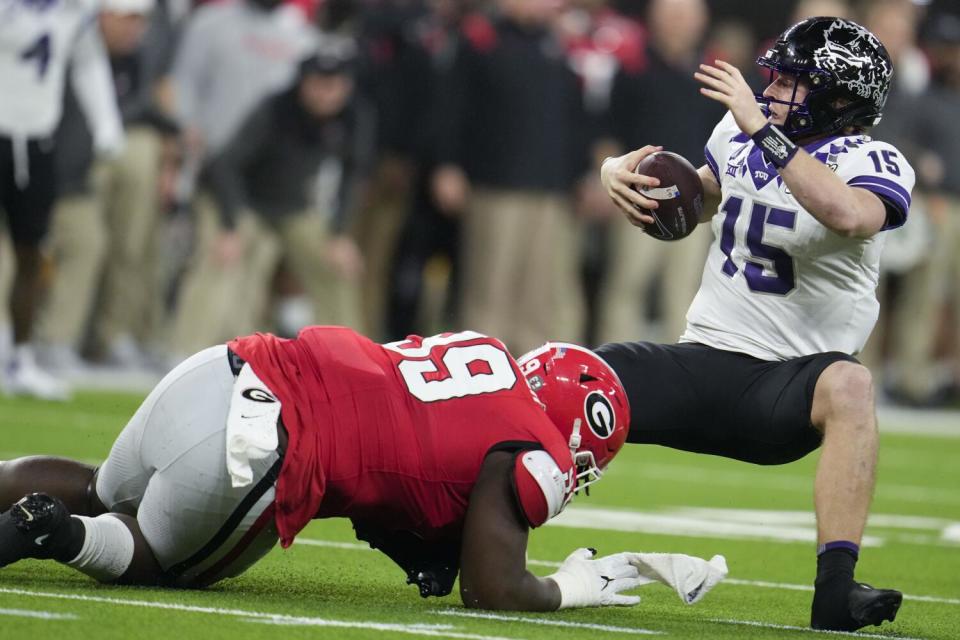 Defensive lineman Bear Alexander played for Georgia last season and is shown sacking TCU quarterback Max Duggan