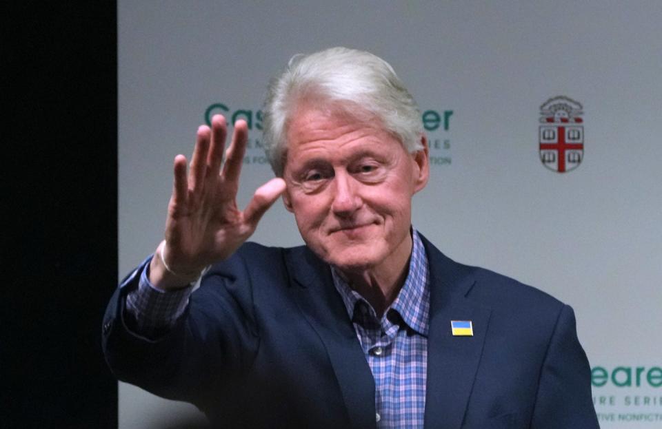 Former President Bill Clinton gestures to the audience during his visit to the Brown University's Pizzitola Sports Center on Tuesday evening.