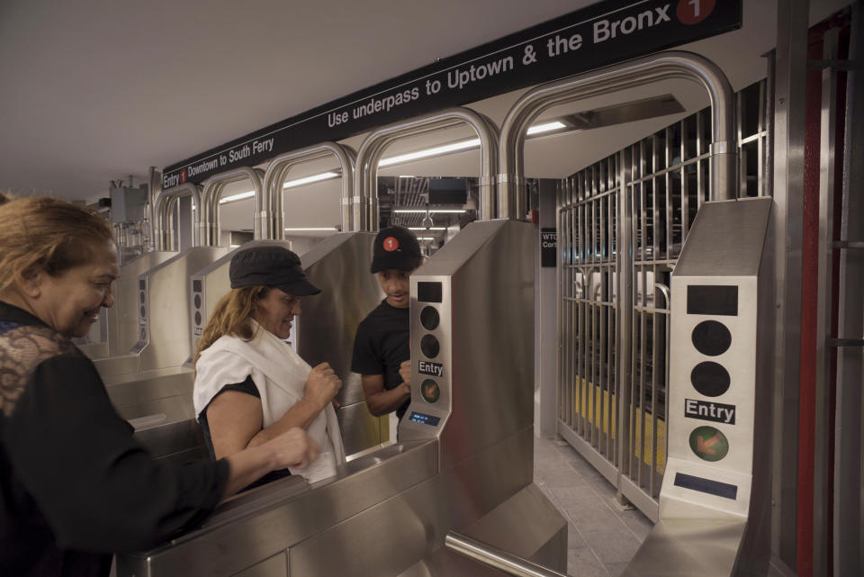 Passengers use a card to enter the newly-opened WTC Cortlandt subway station in New York on Saturday evening, Sept. 8, 2018. (AP Photo/Patrick Sison)