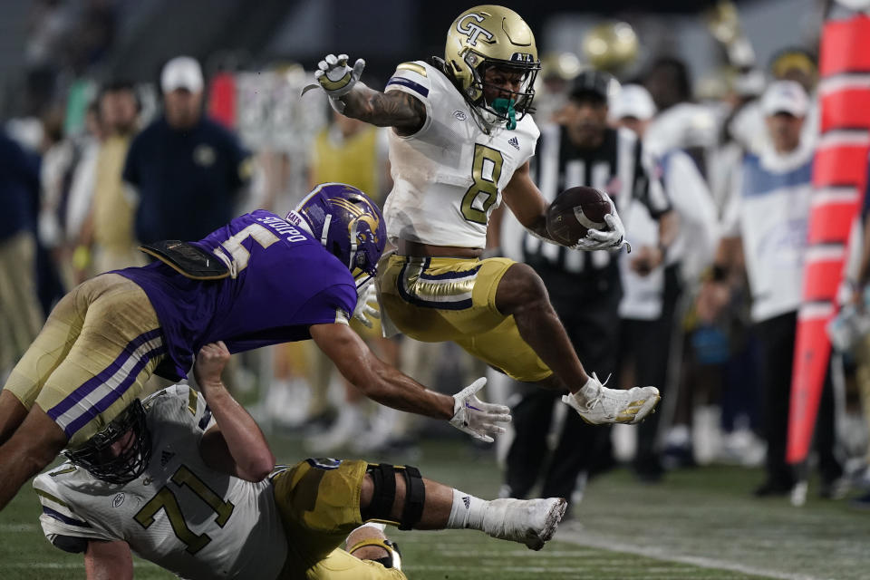 Georgia Tech wide receiver Nate McCollum (8) jumps over Western Carolina safety Mateo Sudipo (5) before scoring a touchdown in the first half during an NCAA college football game, Saturday, Sept. 10, 2022, in Atlanta. (AP Photo/Brynn Anderson)