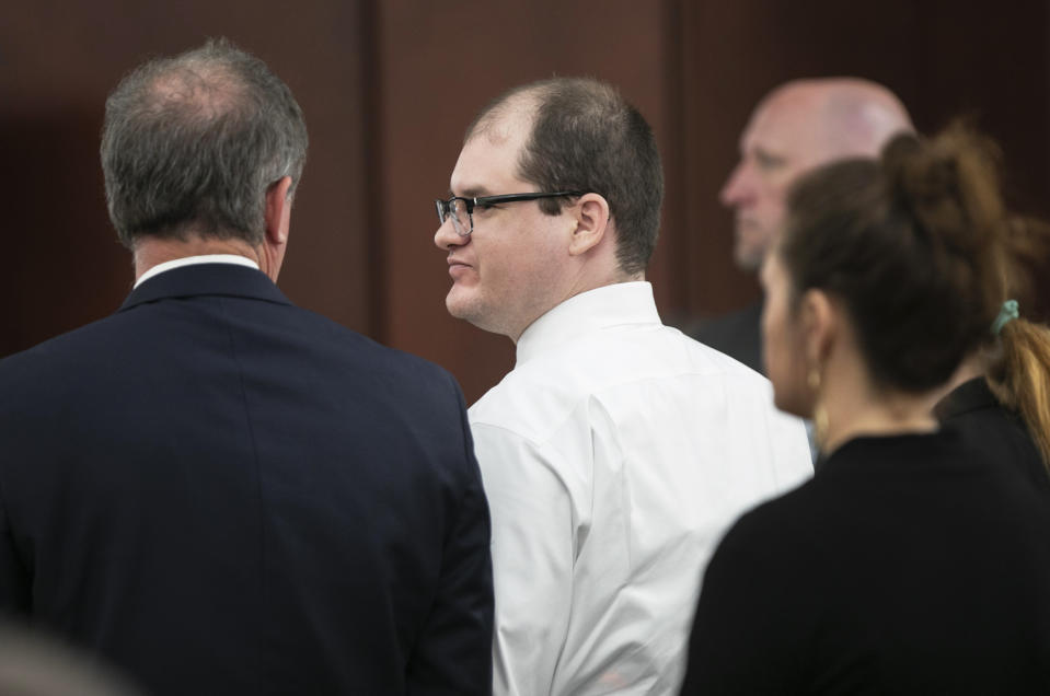 CORRECTS THE CITY TO LEXINGTON - Timothy Jones Jr. stands with his attorney Boyd Young at court in Lexington, S.C., Tuesday, June 4, 2019, after being found guilty in the deaths of his five children in 2014. A jury convicted the South Carolina father of murder Tuesday in the deaths of his children, allowing prosecutors to seek the death penalty. (Tracy Glantz/The State via AP)