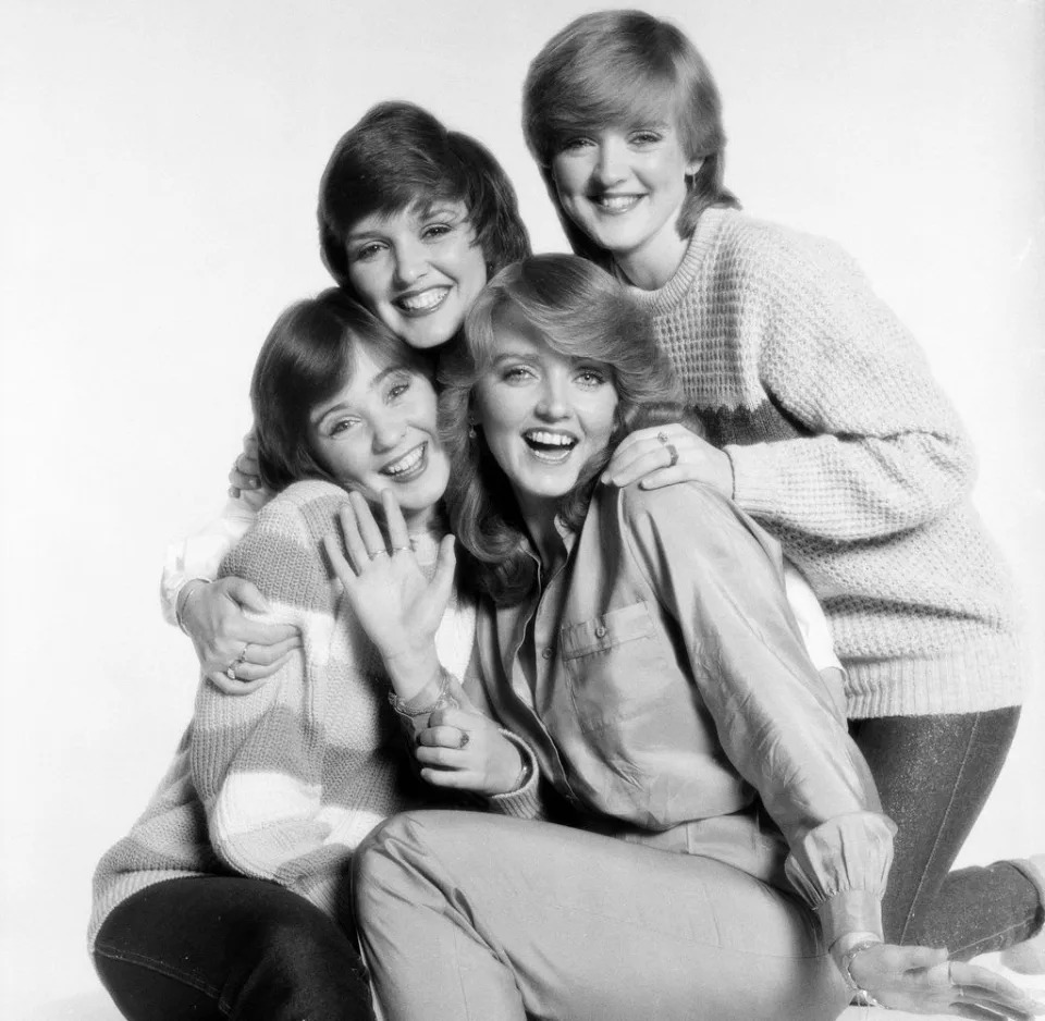 Maureen, Bernie, Linda and Colleen Nolan cuddle together on an old shoot