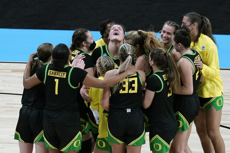 FILE - Oregon forward Sedona Prince, center, celebrates with teammates after a college basketball game against Oregon in the second round of the women's NCAA tournament at the Alamodome in San Antonio, Wednesday, March 24, 2021. Oregon won 57-50. Perhaps the single most impactful social media post to emerge in the NIL era came from the TikTok account of Oregon's Sedona Prince. (AP Photo/Eric Gay, File)