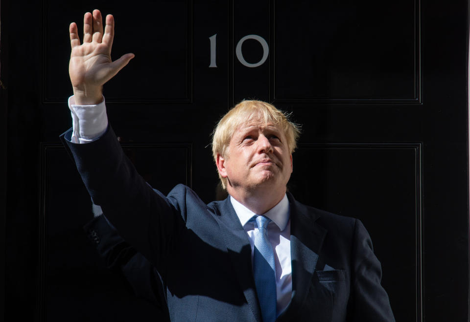 New Prime Minister Boris Johnson waves on the steps of 10 Downing Street, London, after meeting Queen Elizabeth II and accepting her invitation to become Prime Minister and form a new government.