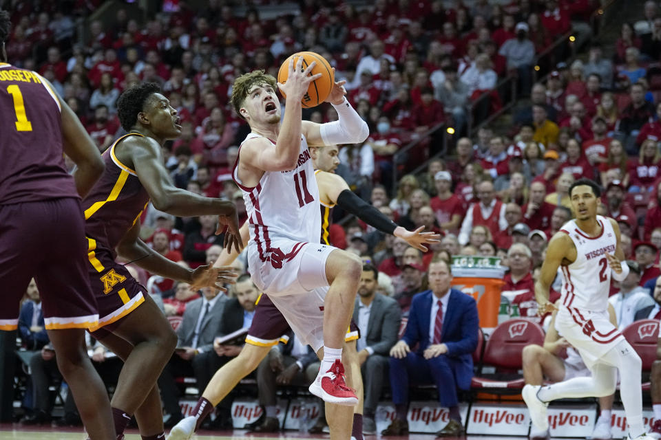 Wisconsin's Max Klesmit (11) shoots against Minnesota's Pharrel Payne (21) during the second half of an NCAA college basketball game Tuesday, Jan. 3, 2023, in Madison, Wis. (AP Photo/Andy Manis)