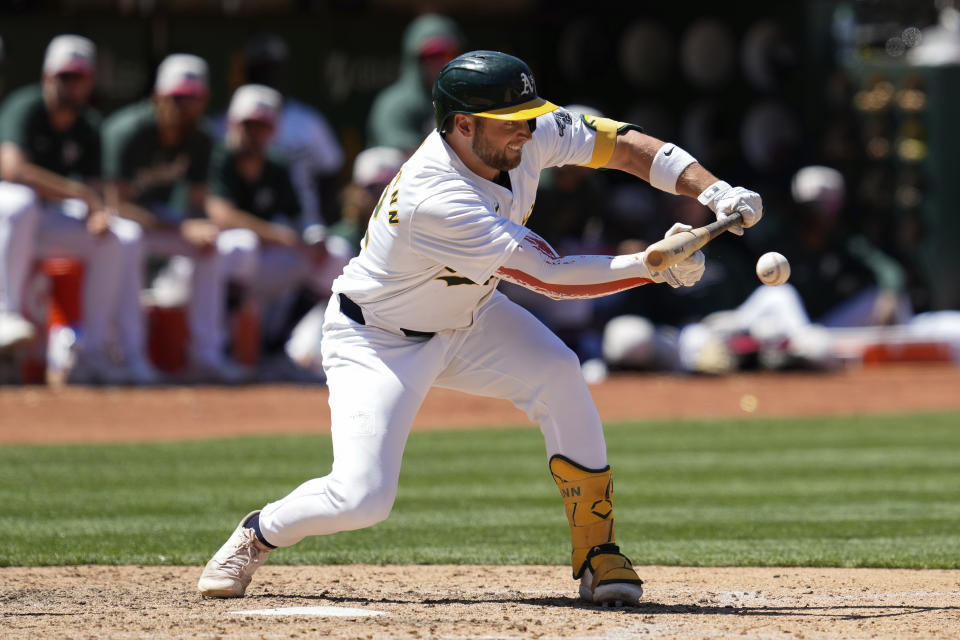 Oakland Athletics' Max Schuemann hits a sacrifice bunt during the sixth inning of a baseball game against the Los Angeles Angels, Thursday, July 4, 2024, in Oakland, Calif. Athletics' Zack Gelof scored. (AP Photo/Godofredo A. Vásquez)