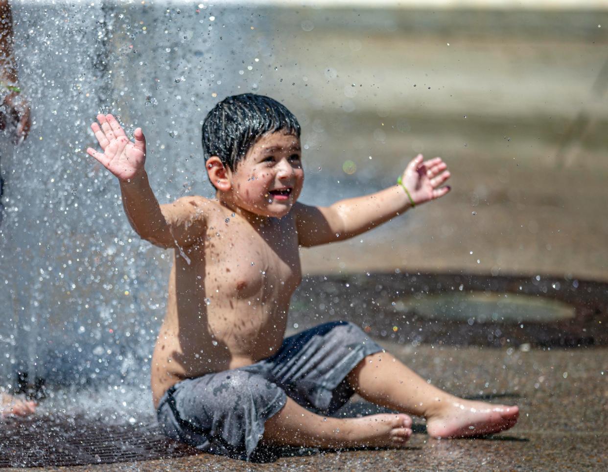 Jose Cornejo, 3, of Rockford, plays in the water at Millennium Fountain on Tuesday, June 21, 2022, in downtown Rockford.