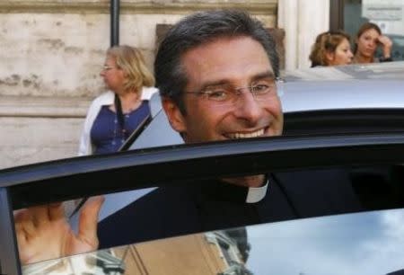 Monsignor Krzystof Charamsa smiles as he leaves at the end of his news conference in downtown Rome October 3, 2015. REUTERS/Alessandro Bianchi