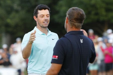 Sep 25, 2016; Atlanta, GA, USA; Rory McIlroy greets Ryan Moore after playing the final playoff hole of the Tour Championship at East Lake Golf Club. Mandatory Credit: Brett Davis-USA TODAY Sports