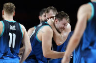 Slovenia's Luka Doncic celebrates with teammates at the end of a men's basketball preliminary round game against Spain at the 2020 Summer Olympics, Sunday, Aug. 1, 2021, in Saitama, Japan. (AP Photo/Charlie Neibergall)