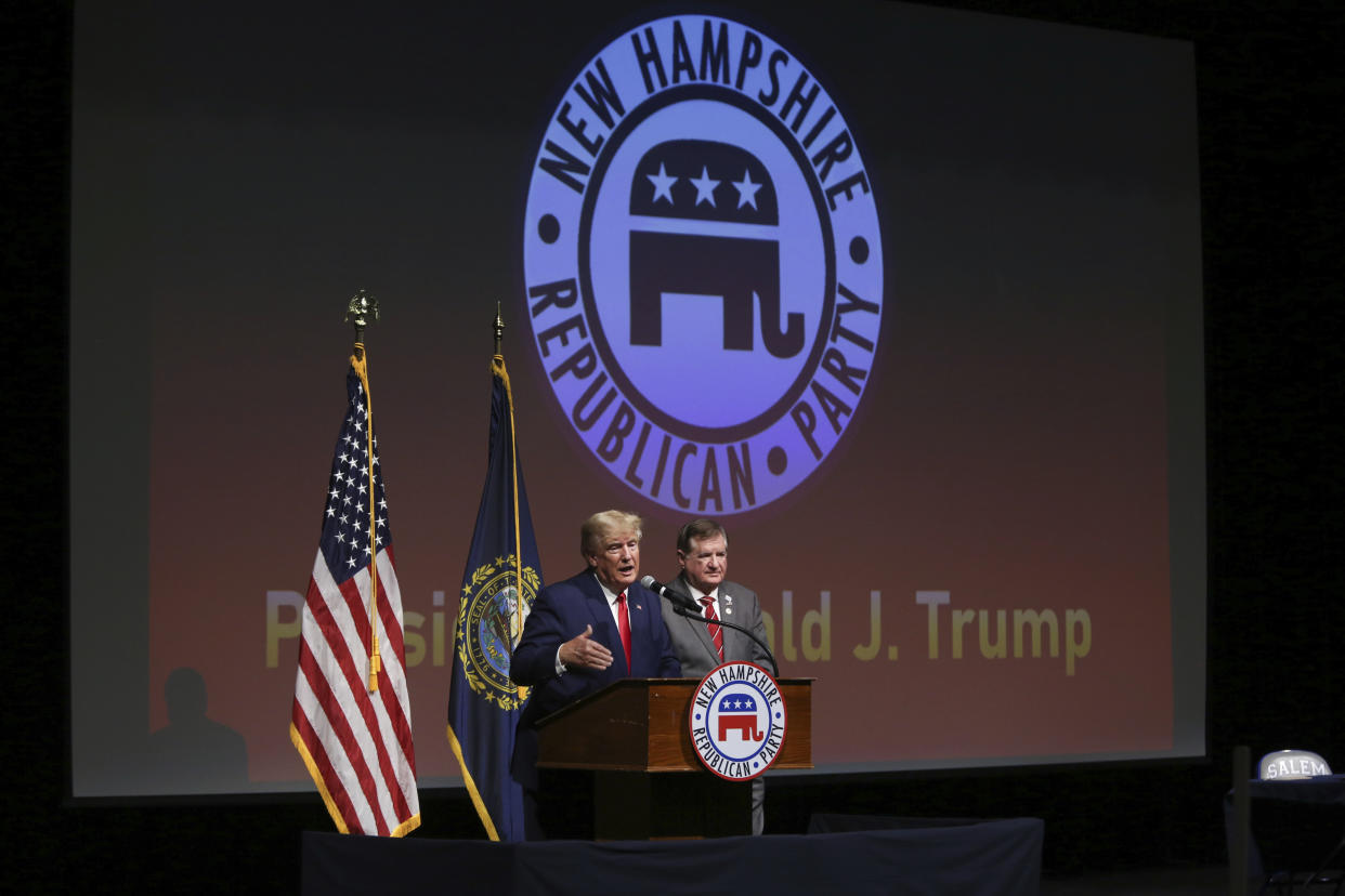 Former President Donald Trump speaks as outgoing Chairman of the New Hampshire GOP Stephen Stepanek looks on during the New Hampshire Republican State Committee 2023 annual meeting, Saturday, Jan. 28, 2023, in Salem, N.H. (AP Photo/Reba Saldanha)