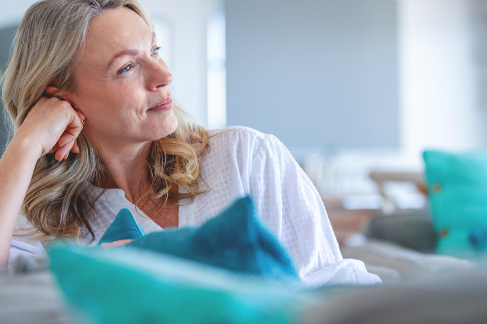 Contemplative woman on couch